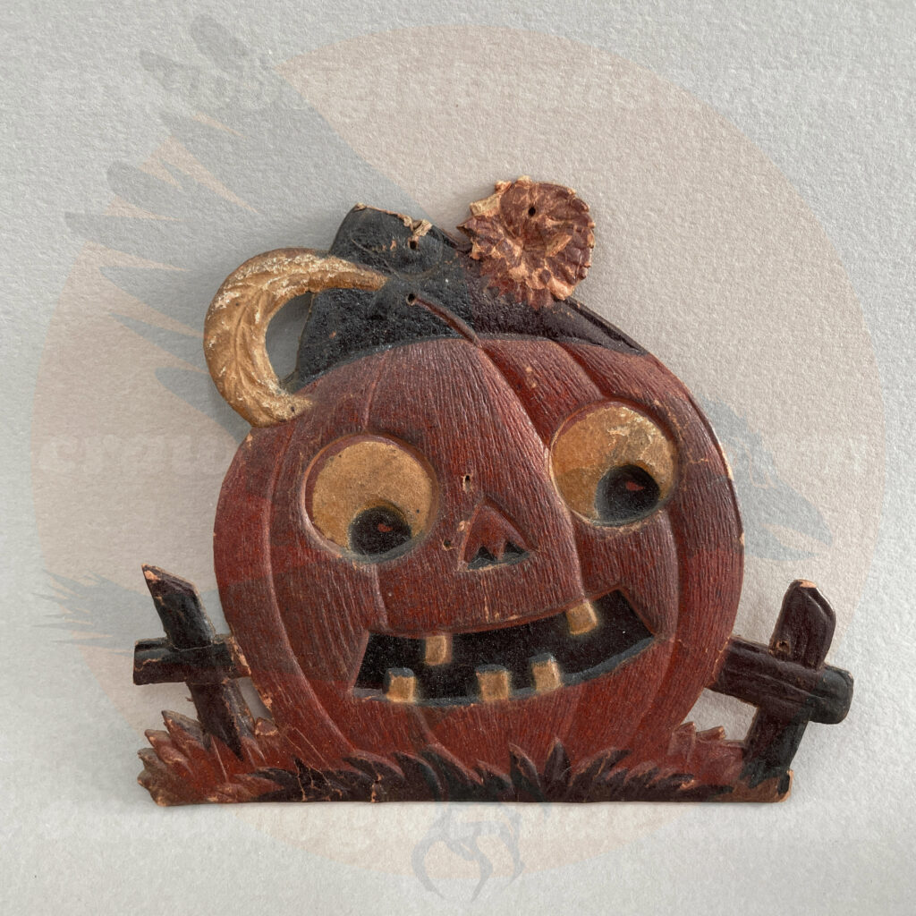 Pumpkin in a pumpkin patch wearing fez cap - a small rare German pressed paper import of vintage Halloween collectible offered by trade/buy/sell Craw-Bogle Trader collector, a companion site to The Halloween Retrospect archive library.