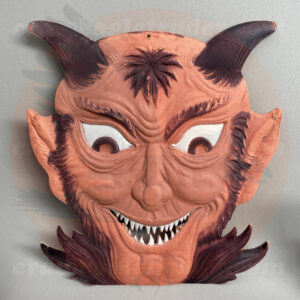 Devil face detailed with black horns and razor teeth, a German import pressed board vintage Halloween collectible offered by Craw-Bogle Trader collector as online trade-buy-sell options as a companion site to The Halloween Retrospect archive library.