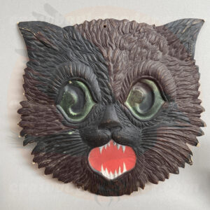 Black cat faced with detailed fur, and large green eyes a German import pressed board diecut antique-vintage Halloween collectible offered by Craw-Bogle Trader collector online store of trade-buy-sell website, a companion site to The Halloween Retrospect archive library.