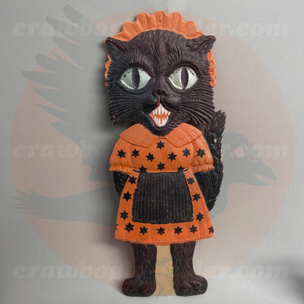 Fancy-dressed female black cat in bonnet, and starry dirndl, a German import pressed board vintage Halloween collectible offered by trade/buy/sell Craw-Bogle Trader collector, a companion site to The Halloween Retrospect archive library.