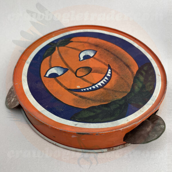 Vintage Halloween collectible tambourine noisemaker featuring razor-teeth jack o'lantern with leafy bowtie - offered by trade/buy/sell Craw-Bogle Trader collector, a companion site to The Halloween Retrospect archive library.