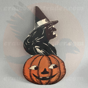 Classic wicked witch with hairy chin over a Jack O'lantern - a Beistle diecut paper vintage Halloween collectible offered by trade/buy/sell Craw-Bogle Trader collector, a companion site to The Halloween Retrospect archive library.