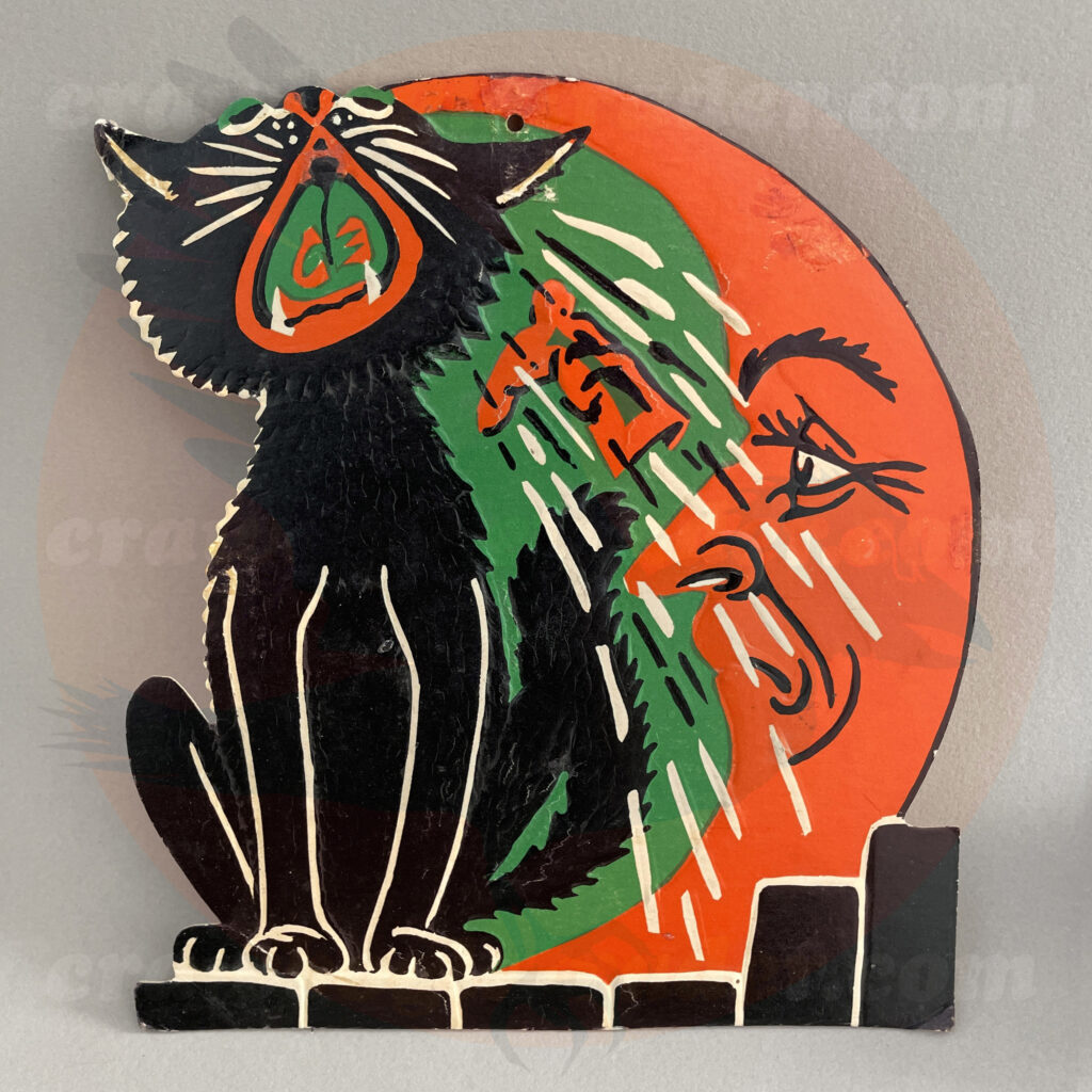 Black cat singing under the man in the moon and getting a boot in the face - a Beistle embossed diecut paper vintage Halloween collectible offered by trade/buy/sell Craw-Bogle Trader collector, a companion site to The Halloween Retrospect archive library.