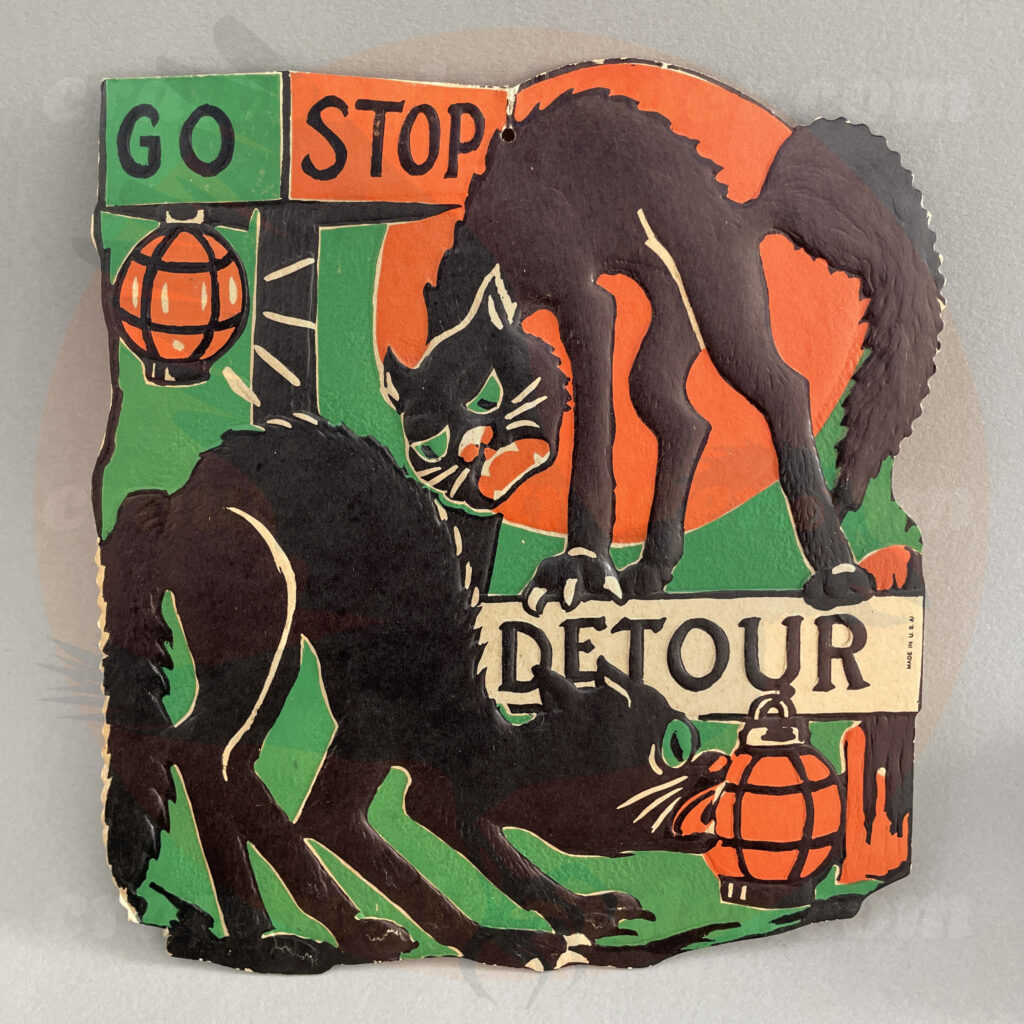 Two black cats by a lantern under a full moon and traffic signs Go Stop Detour - a Beistle embossed diecut paper vintage Halloween collectible offered by trade/buy/sell Craw-Bogle Trader collector, a companion site to The Halloween Retrospect archive library.
