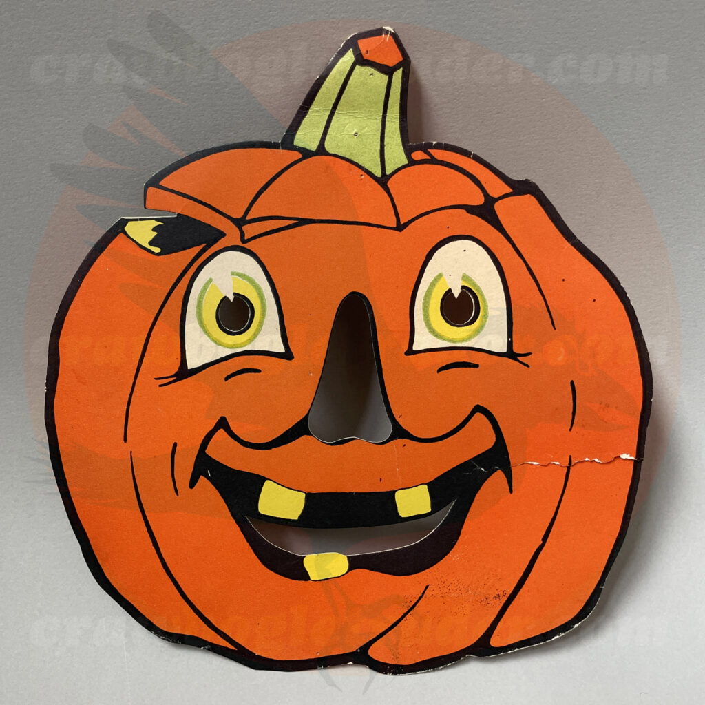 Front side - One classic vintage Halloween Gibson orange and black jack o'lantern pumpkin face with yellow and green color highlights that appears to be a mask with cut-out facial features - and just one of numerous ephemera items from the collection of Craw Bogle Trader up for trader (with consideration of buy and sell options also available under certain circumstances). Please contact us.