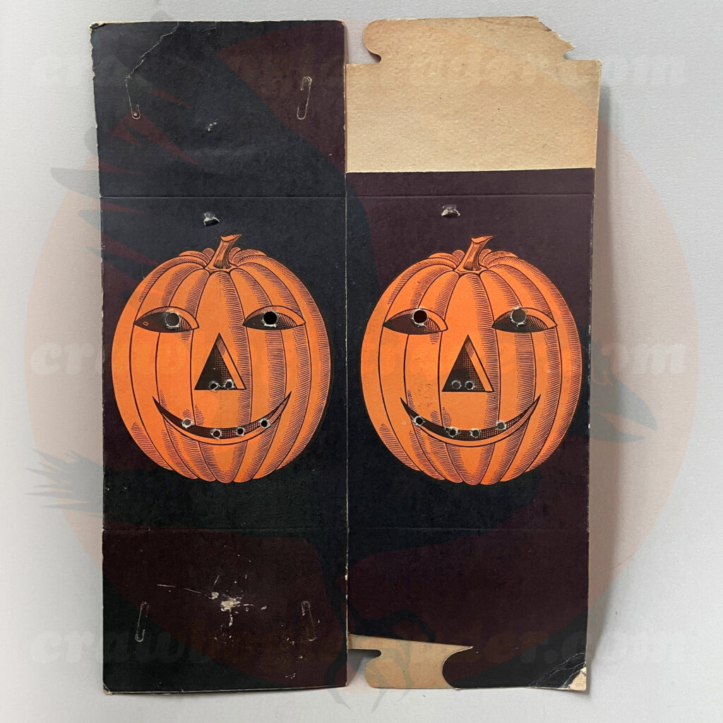Unknown box (perhaps food container or lighting) featuring a hashmark style Jack O'Lantern face in a field of black with hole-punch eyes, nose, and mouth. One of many unusual items from Craw Bogle Trader that is up for trade options (while buying and selling may be also considered upon contact of the collector).