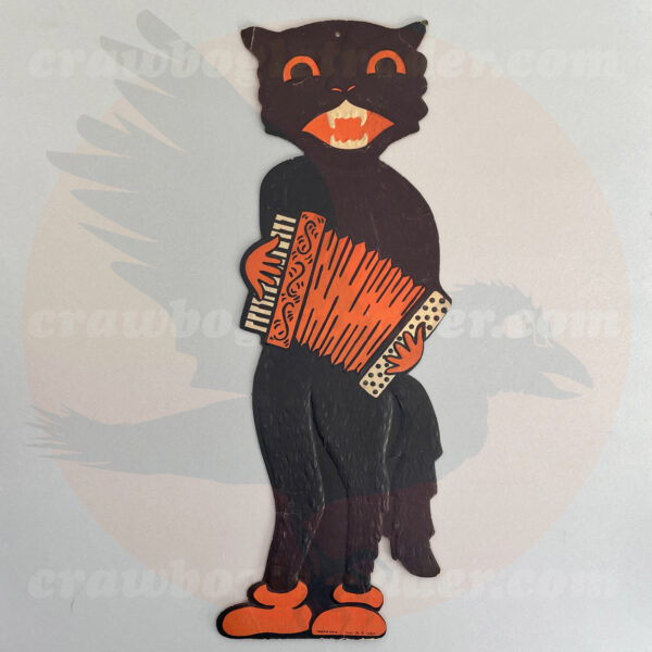 Vintage Halloween American of hep-cat with black fur wearing orange gloves playing a squeeze-box accordion from a classic Americana Beistle decoration set of musicians measuring 20-inch tall and available as a trade item from Craw Bogle Trader (noting also that buying and selling of vintage Halloween collectibles considered upon contacting online shop with further details).