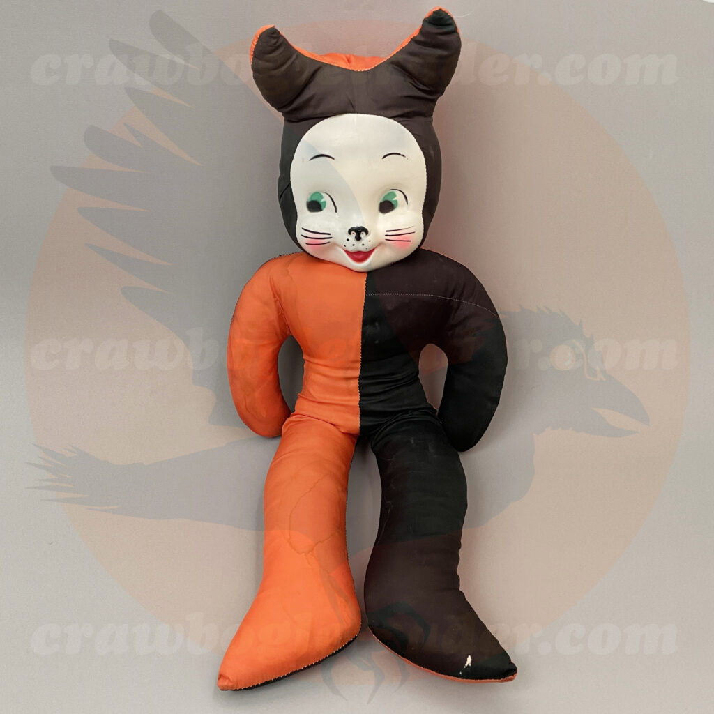 Old mid-century Halloween carnival prize cat white-face with green eyes and whiskers on plastic form surrounded by half-orange and half-black stuffed fabric, available for-trade from Craw Bogle Trader (which may have buy-sell options upon contacting the vintage Halloween collector).